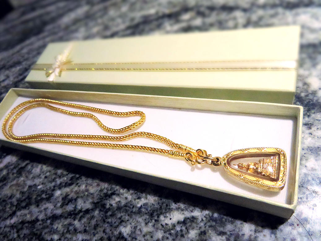 A Thai gold chain with a Buddha amulet in a gift box A Thai gold chain with Buddha amulet